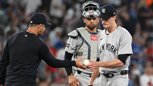 Jul 23, 2025; Toronto, Ontario, CAN; New York Yankees manager Aaron Boone (17) takes the ball from pitcher Max Fried (54) in the sixth inning against the Toronto Blue Jays at Rogers Centre. Mandatory Credit: Dan Hamilton-Imagn Images