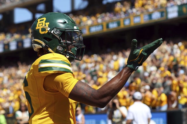 Baylor wide receiver Ashtyn Hawkins blows a kiss to the crowd after a touchdown during a 2024 game in Waco. Baylor University has filed a trademark infringement lawsuit against the trustees of Boston University over the use of “an interlocking BU design.”