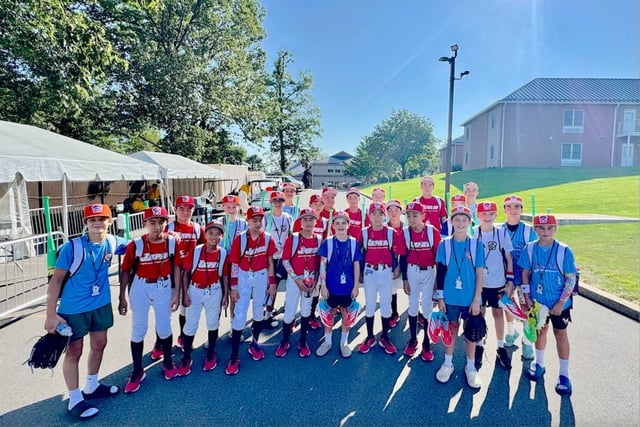 The Clarendon Hills Little League team poses for a photo with the team from Japan after arriving for the Little League World Series in Williamsport, Pennsylvania. (Ted Kaczmarski)