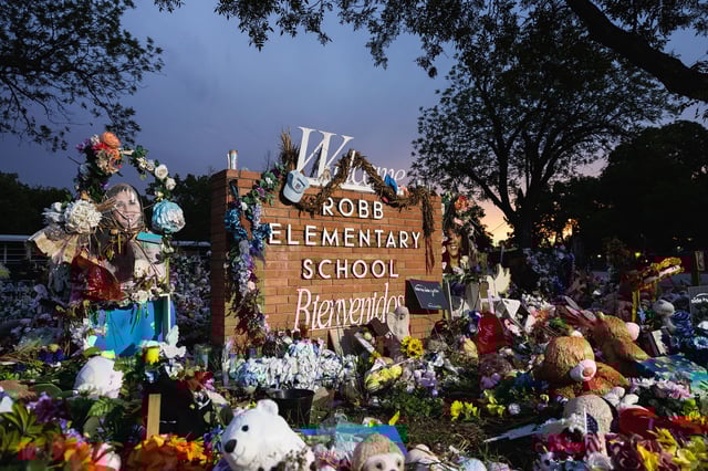 UVALDE, TX - AUGUST 24: The sun sets behind the memorial for the victims of the massacre at Robb Elementary School on August 24, 2022 in Uvalde, Texas. The Consolidated Independent School District Board today fired Police Chief Pete Arredondo over police response during the May 24 massacre, America’s deadliest school shooting since 2012.  (Photo by Jordan Vonderhaar/Getty Images)