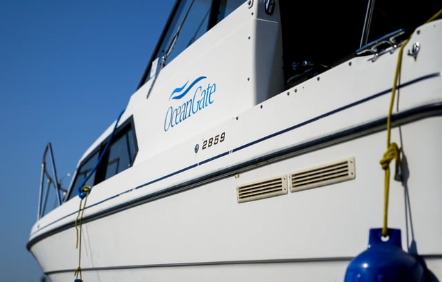 A boat with the OceanGate logo is parked on a lot near the OceanGate offices on June 22, 2023, in Everett, Wash. The submersible Titan went missing on June 18, 2023. The U.S. Coast Guard confirmed it imploded near the Titanic shipwreck site, killing everyone on board. (AP Photo/Lindsey Wasson)