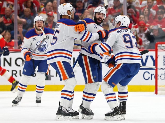 SUNRISE, FLORIDA - JUNE 12: Jake Walman #96, Darnell Nurse #25 and Ryan Nugent-Hopkins #93 of the Edmonton Oilers celebrate after Walman scored against the Florida Panthers during the third period i in Game Four of the 2025 Stanley Cup Final at Amerant Bank Arena on June 12, 2025 in Sunrise, Florida.