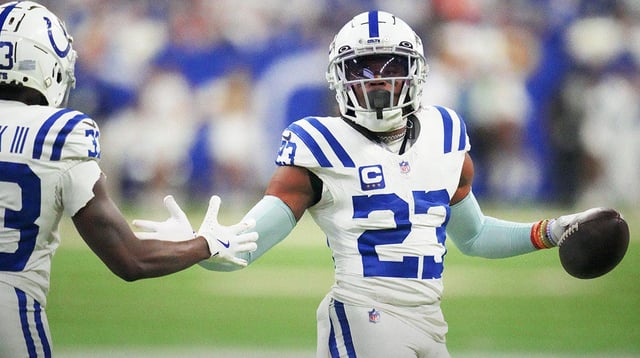 Dec 22, 2024; Indianapolis, Indiana, USA; Indianapolis Colts cornerback Kenny Moore II (23) high fives Indianapolis Colts cornerback Samuel Womack III (33) after making an interception at the end of the game during a game against the Tennessee Titans at Lucas Oil Stadium. Mandatory Credit: Christine Tannous/USA Today Network via Imagn Images
