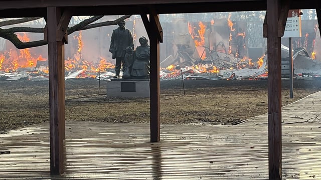 A fire burns at the Ukrainian Cultural Heritage Village near Elk Island National Park, Alta. in this Alberta RCMP handout photo posted on their Facebook page, on Friday, April 18, 2025. Firefighters who battled a wind-fanned grass fire that spread to the Ukrainian Cultural Heritage Village east of Edmonton managed to save the historic structures at the open-air museum, but provincial officials say the visitor centre buildings were lost. THE CANADIAN PRESS/Handout - Facebook, Alberta RCMP (Mandatory Credit)