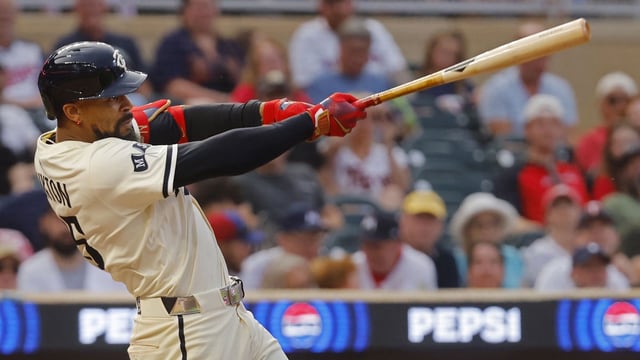Jul 25, 2025; Minneapolis, Minnesota, USA; Minnesota Twins center fielder Byron Buxton (25) hits a sacrifice fly against the Washington Nationals in the fifth inning at Target Field. Mandatory Credit: Bruce Kluckhohn-Imagn Images