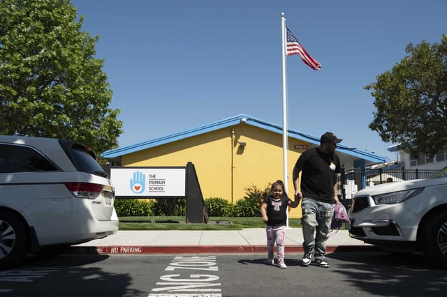 Parents pick up their kids outside of The Primary School created by the Chan Zuckerberg Initiative in East Palo Alto on Monday, April 28, 2025.