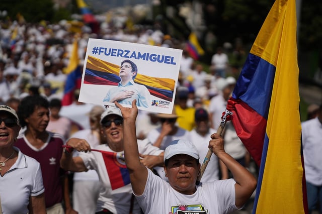 People hold up banners of presidential pre-candidate Miguel Uribe Turbay during a protest to demand a reduction in violence in Cali, Colombia on June 15, 2025.