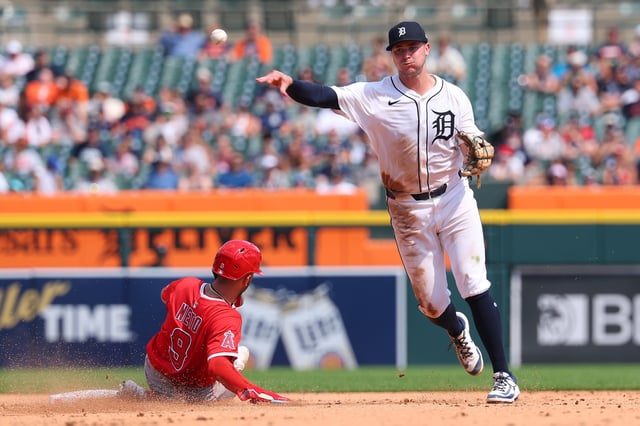 DETROIT, MICHIGAN - AUGUST 10: Trey Sweeney #27 of the Detroit Tigers turns a seventh inning double play over the sliding Zach Neto #9 of the Los Angeles Angels at Comerica Park on August 10, 2025 in Detroit, Michigan.