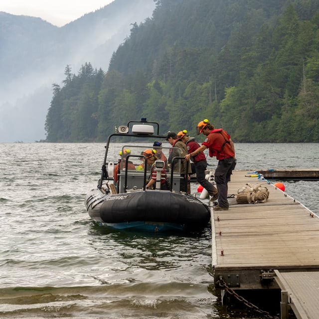 A firefighting crew is seen at Cameron Lake on their way to the Wesley Ridge wildfire, burning about 60 kilometres northwest of Nanaimo, B.C., on Sunday, Aug. 10, 2025. THE CANADIAN PRESS/Handout- BC Wildfire Service (Mandatory Credit)