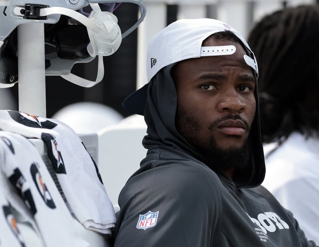 Micah Parsons #11 of the Dallas Cowboys sits on the sidelines in the first half of a NFL Preseason 2025 game against the Los Angeles Rams at SoFi Stadium on August 09, 2025 in Inglewood, California.