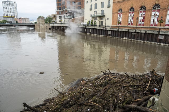 Debris piles up on a bridge piling on the Milwaukee River after heavy rain in the area on August 10, 2025 in Milwaukee, Wisconsin.