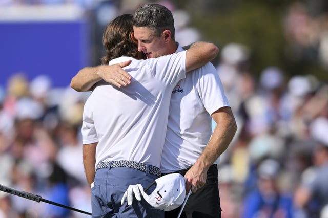 Aug 10, 2025; Memphis, Tennessee, USA; Tommy Fleetwood and Justin Rose hug after the match during the final round of the FedEx St. Jude Championship golf. Mandatory Credit: Steve Roberts-Imagn Images