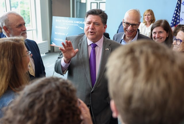 Gov. JB Pritzker speaks speaks with a group of education and health professionals following an event supporting National Immunization Awareness Month at School District 21 in Wheeling on Aug. 11, 2025. (Stacey Wescott/Chicago Tribune)