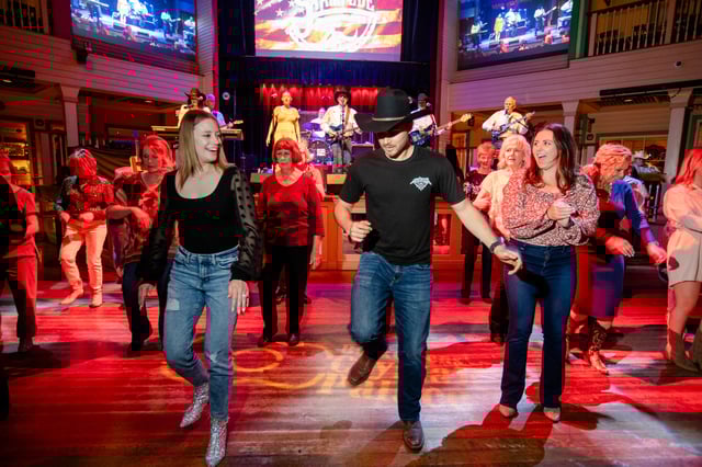 Line dancers dance to country band Stampede at Buck Owens’ Crystal Palace in Bakersfield, Calif., on April 14, 2023.
