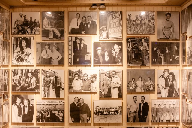 Historical photos, many of Buck Owens with famous musicians, adorn the walls at Buck Owens’ Crystal Palace in Bakersfield, Calif., on April 14, 2023.