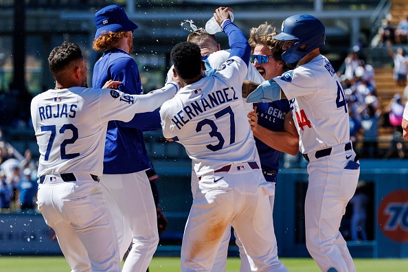LOS ANGELES, CA – JULY 23, 2025:  Los Angeles Dodgers outfielder Teoscar Hernández (37) pours water on Los Angeles Dodgers first base Freddie Freeman (5) as other teammates celebrate Freeman’s walk-off hit  scoring  two runs to beat the Minnesota Twins 4-3  at Dodger Stadium on July 23, 2025 in Los Angeles, California.(Gina Ferazzi / Los Angeles Times via Getty Images)