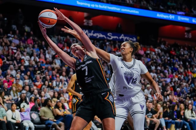 Haley Peters #7 of the Connecticut Sun and Iliana Rupert #12 of the Golden State Valkyries go for the rebound during the second half of a WNBA basketball game at Mohegan Sun Arena on July 27, 2025 in Uncasville, Connecticut.