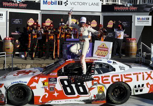 Connor Zilisch stumbles on his race car while celebrating in victory lane after winning the NASCAR Xfinity Series rae at Watkins Glen International on Aug. 9, 2025.