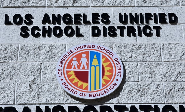 A sign at the Los Angeles Unified School District Transportation Services near district headquarters in Los Angeles, California on January 9, 2019. – Teachers in the nation’s second largest school district have postponed a potential strike planned for January 10 to January 14. (Photo by Frederic J. BROWN / AFP) (Photo by FREDERIC J. BROWN/AFP via Getty Images)