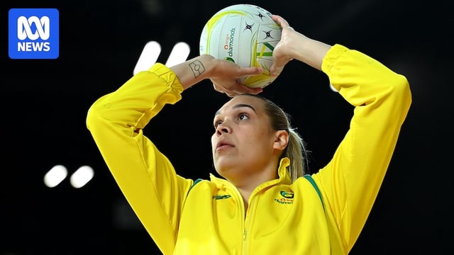Donnell Wallam of Australia warms up in a track suit, shooting the netball