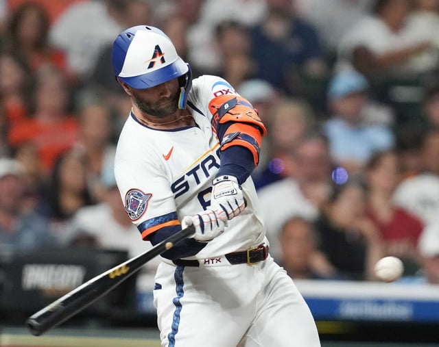 Houston Astros first base Christian Walker (8) connects for a two-run double in the third inning against the Boston Red Sox at Daikin Park in Houston on Monday, Aug. 11, 2025.