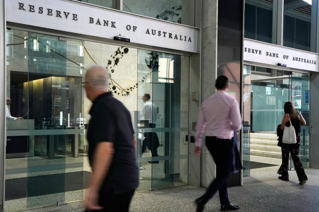 FILE - People arrive at the Reserve Bank of Australia in Sydney, Dec. 6, 2022. (AP Photo/Rick Rycroft, File)
