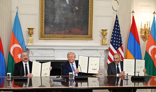 WASHINGTON D.C., UNITED STATES - AUGUST 8: (----EDITORIAL USE ONLY - MANDATORY CREDIT - 'AZERBAIJAN PRESIDENCY / HANDOUT' - NO MARKETING NO ADVERTISING CAMPAIGNS - DISTRIBUTED AS A SERVICE TO CLIENTS----) U.S. President Donald Trump (C), Azerbaijani President Ilham Aliyev (L), and Armenian Prime Minister Nikol Pashinyan (R) sign the joint declaration 'peace roadmap' following their trilateral meeting at the White House in Washington D.C., United States on August 08, 2025. (Photo by Azerbaijan Presidency/Anadolu via Getty Images)