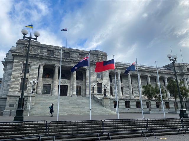 A pedestrian walks past the New Zealand Parliament Buildings in Wellington, New Zealand, June 14, 2022. REUTERS/Lucy Craymer/File Photo
