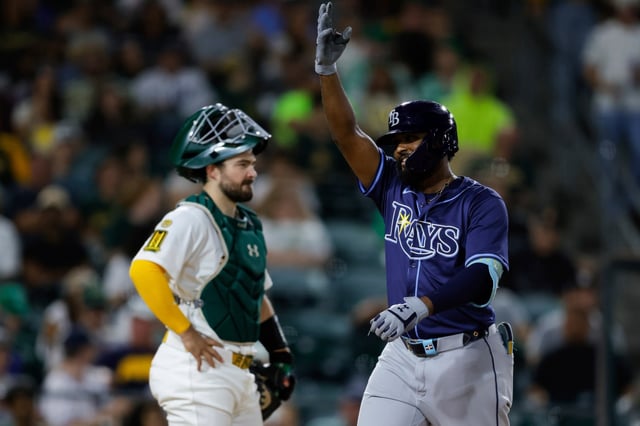 Tampa Bay Rays&#39; Junior Caminero, right, celebrates at home plate after hitting a one-run home run during the seventh inning of a baseball game against the Athletics Monday, Aug. 11, 2025, in West Sacramento, Calif. (AP Photo/Sergio Estrada)