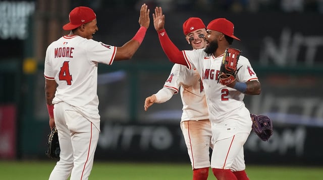 Aug 11, 2025; Anaheim, California, USA; Los Angeles Angels second baseman Christian Moore (4), shortstop Zach Neto (9) and second baseman Luis Rengifo (2) celebrate after the game against the Los Angeles Dodgers at Angel Stadium. Mandatory Credit: Kirby Lee-Imagn Images