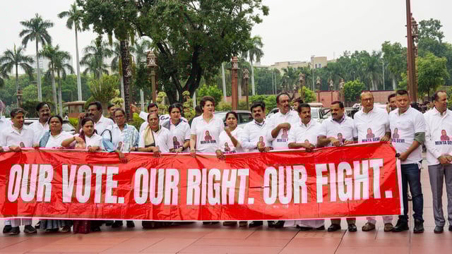 Members of the INDIA bloc hold a banner that reads ‘Our vote. Our right. Our fight,’ as they stage a protest over 'poll fraud' issues during today's parliament session.