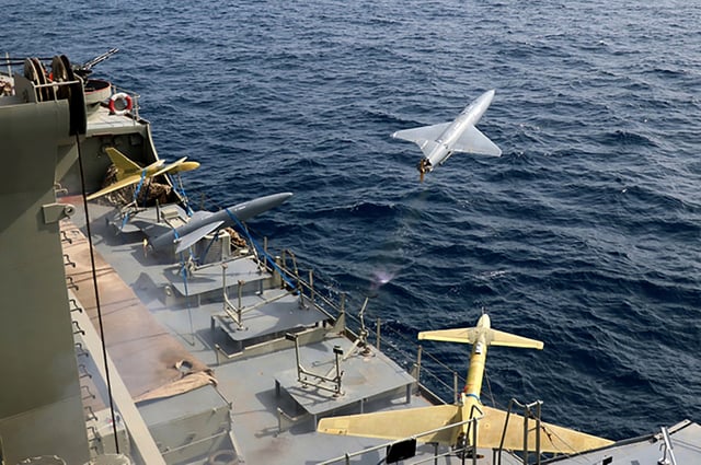 FILE - In this photo released by the Iranian Army on Aug. 25, 2022, a drone is launched from a warship in a military drone drill in Iran. As protests rage at home, Iran&#39;s theocratic government is increasingly flexing its military muscle abroad. That includes supplying drones to Russia that now kill Ukrainian civilians, running drills in a border region with Azerbaijan and bombing Kurdish positions in Iraq.