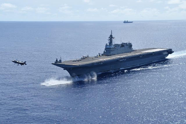 In this photo provided on August 12, 2025, an F-35B fighter jet takes off from the Japanese aircraft carrier JS Kaga in the northern Philippine Sea, while the British aircraft carrier HMS Prince of Wales sails nearby in the background.