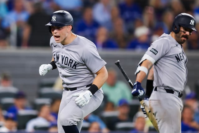 TORONTO, CANADA - JULY 22: Ben Rice #22 of the New York Yankees celebrates at the plate with Austin Wells #28 as he hits a solo-home run in the ninth inning of their MLB game against the Toronto Blue Jays at Rogers Centre on July 22, 2025 in Toronto, Ontario, Canada. (Photo by Cole Burston/Getty Images)