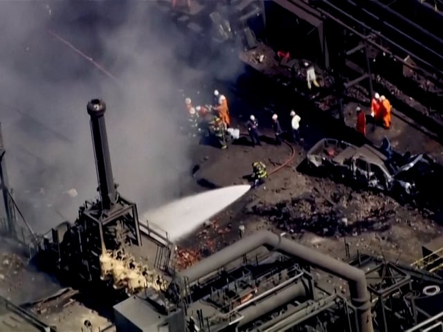 Firefighters spray water on the site of an explosion at U.S. Steel's Clairton Coke Works plant in Clairton, Pennsylvania, U.S. August 11, 2025 in this screengrab obtained from an aerial video.  ABC Affiliate WTAE via REUTERS. NO RESALES. NO ARCHIVES. THIS IMAGE HAS BEEN SUPPLIED BY A THIRD PARTY. BEST QUALITY AVAILABLE.