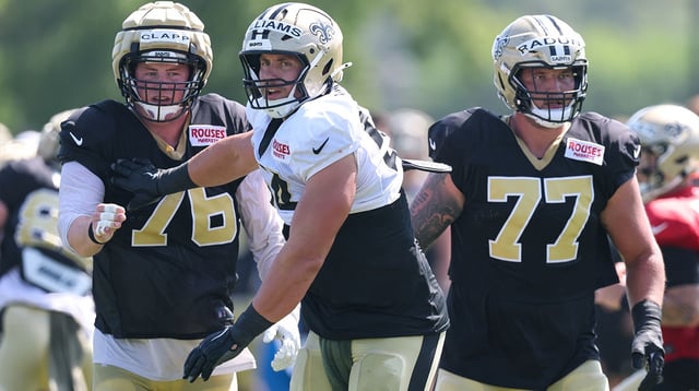 Jul 28, 2025; Metairie, LA, USA; aNew Orleans Saints center Will Clapp (76) and offensive tackle Dillon Radunz (77) Ochsner Sports Performance Center. Mandatory Credit: Stephen Lew-Imagn Images