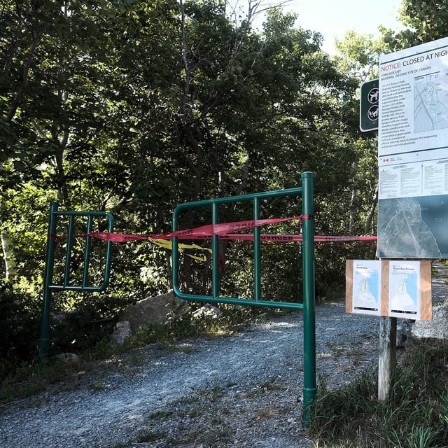 Tape and signage prevents people entering wooded park space at York Redoubt National Historic Site trail in Nova Scotia.