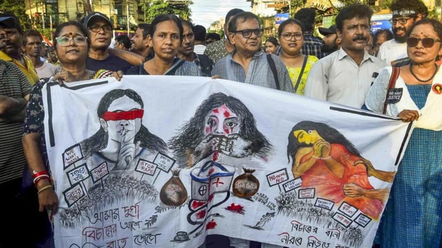 Doctors and others take part in a protest rally to mark one year of the rape and murder of a trainee doctor at the RG Kar Medical College and Hospital, in Kolkata, on Aug. 9 (PTI)