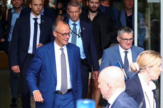 German Chancellor Friedrich Merz walks after attending a press conference about domestic and foreign policy issues at the House of the 'Bundespressekonferenz' in Berlin, Germany July 18, 2025. REUTERS/Christian Mang/File Photo