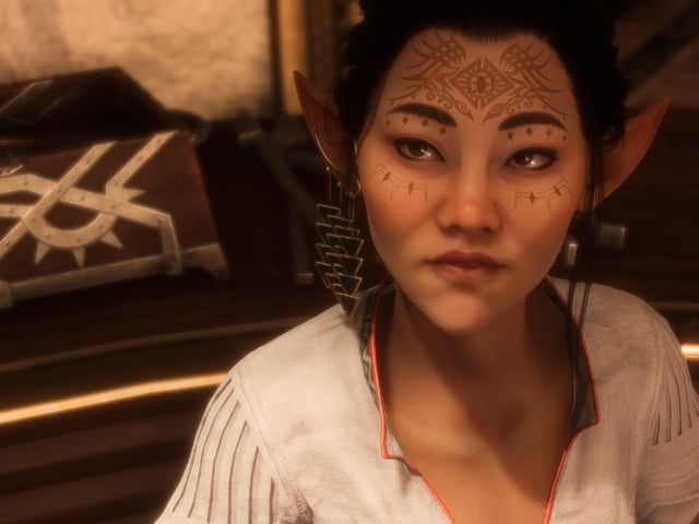 Bellara from Dragon Age: The Veilguard, a Dalish veil jumper elf, looks in a smitten fashion up at the player character.