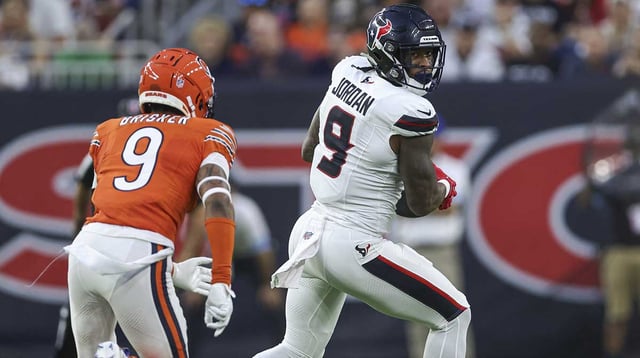 Sep 15, 2024; Houston, Texas, USA; Houston Texans tight end Brevin Jordan (9) makes a reception as Chicago Bears safety Jaquan Brisker (9) defends during the first quarter at NRG Stadium.