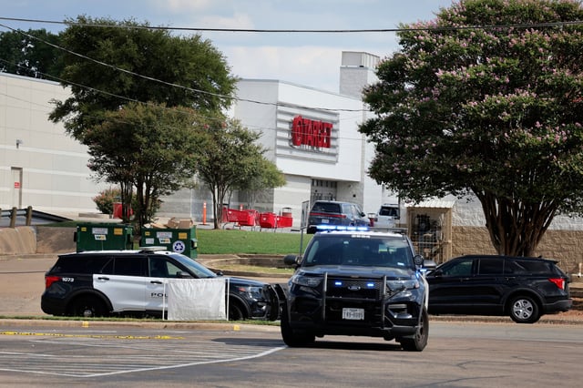 Police monitor the scene near a Target after a shooting in Austin, Texas, Monday, Aug. 11, 2025. (AP Photo/Stephen Spillman)