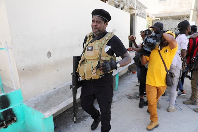 Former police officer Jimmy "Barbecue" Cherizier, and leader of an alliance of armed groups, walks past journalists, in Port-au-Prince, Haiti, March 11, 2024. REUTERS/Ralph Tedy Erol/File Photo
