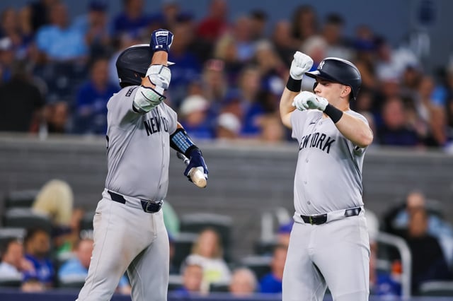 TORONTO, CANADA - JULY 22: Ben Rice #22 of the New York Yankees celebrates at the plate with Austin Wells #28 as he hits a solo-home run in the ninth inning of their MLB game against the Toronto Blue Jays at Rogers Centre on July 22, 2025 in Toronto, Ontario, Canada