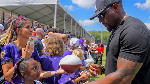 Former Ravens linebacker Ray Lewis visits practice and signs autographs for fans. Lewis, a two-time Super Bowl champion, also spoke to the team. (Karl Merton Ferron/Staff)