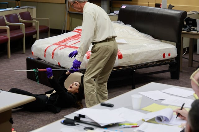 Crime Scene Investigations and Reconstruction witness Thomas S. Hill explains to the jury how he reenacted the crime scene and killing of Silvia Garza in 2019. Prosecutor Jaclyn Broudy lays on the ground to demonstrate where the victim would have ended up after being pulled by her feet from the bed. This during Adam Crespo’s trial on a charge of murder without premeditation at the Broward County Courthouse in Fort Lauderdale on Tuesday, July 29, 2025. Crespo is accused of killing his girlfriend, Garza, during an argument.  (Mike Stocker/South Florida Sun Sentinel)