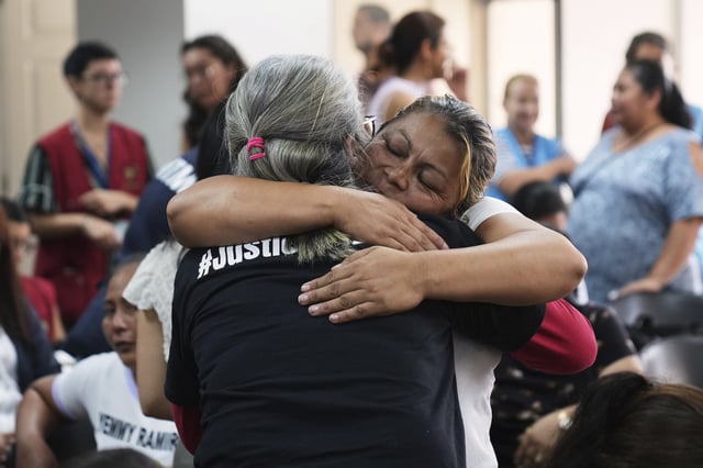 Relatives of the 41 girls killed in a fire at a government-run facility for at-risk girls in 2017, embrace in a courtroom during a hearing for seven people accused of responsibility, in Guatemala City, Tuesday, Aug. 12, 2025. (AP Photo/Moises Castillo)