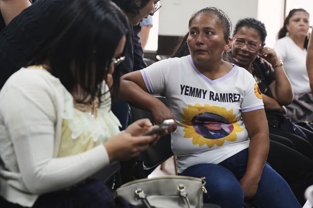 Elsa Siquin, right, wears a T-shirt with a portrait of her daughter, Yemmy Ramirez, one of 41 girls killed in a fire at a government-run facility for at-risk girls in 2017, during a hearing for those accused of responsibility in Guatemala City, Tuesday, Aug. 12, 2025. (AP Photo/Moises Castillo)