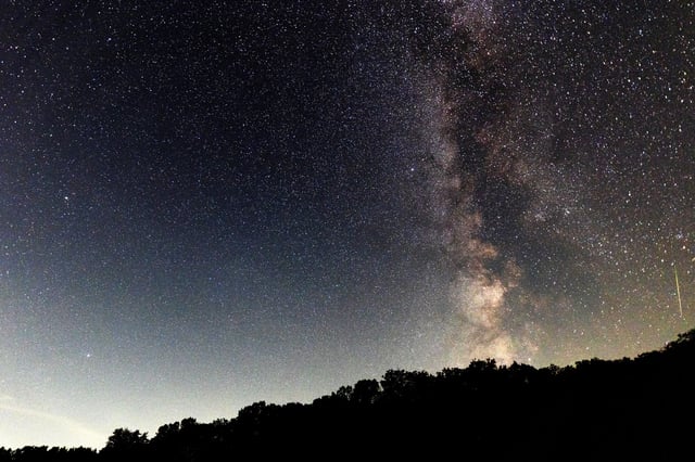 A meteor streaks across the sky during the Perseids meteor shower peak at Pedernales Falls State Park on August 12, 2024 in Johnson City, Texas.