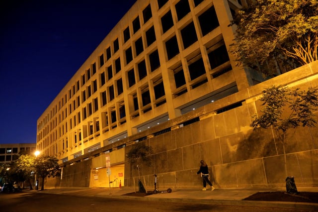 A person walks by the Department of Labor headquarters in Washington, D.C., U.S., May 13, 2021. REUTERS/Andrew Kelly/File Photo